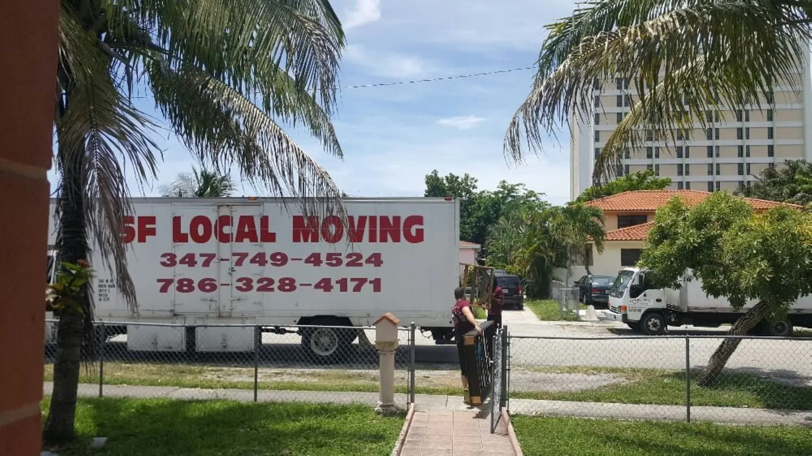 SF Local Moving branded truck parked on a South Florida street with palm trees